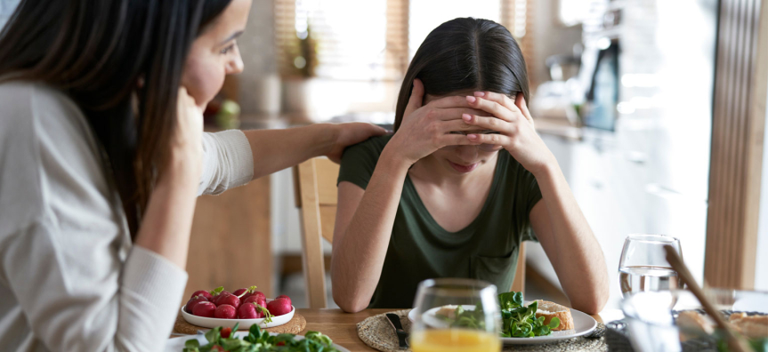 Mother and daughter around a kitchen table