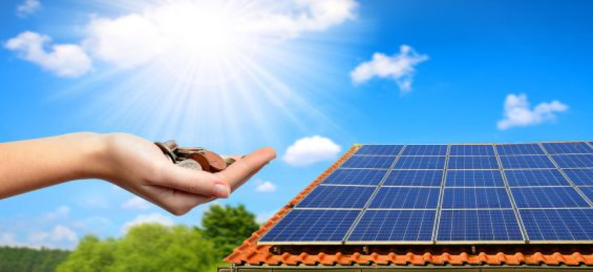 hand holding coins and solar panel