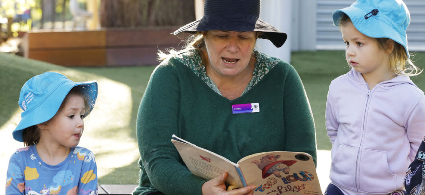 Councils educator reading to a student 