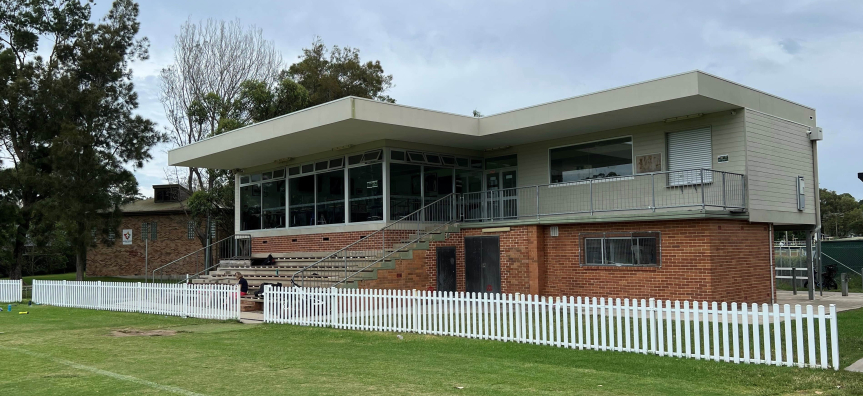 Two story building in front of oval