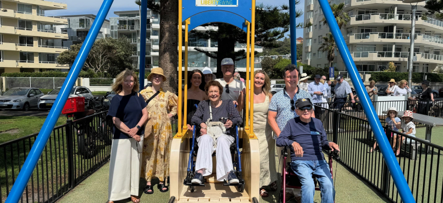 Jean Hay AM, her husband David & family on the Liberty Swing at the naming of her playground