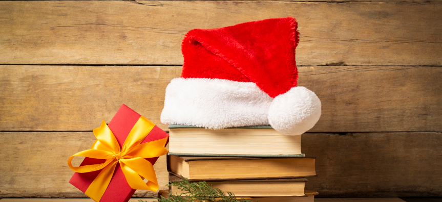 Santa hat sits atop a stack of books