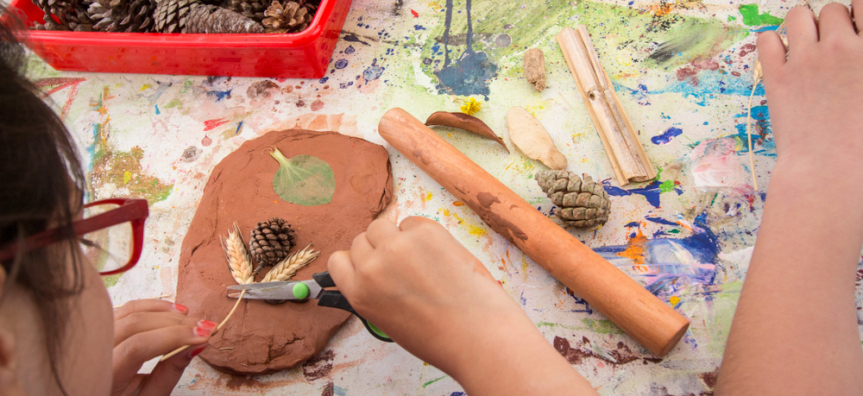 child with clay and nature