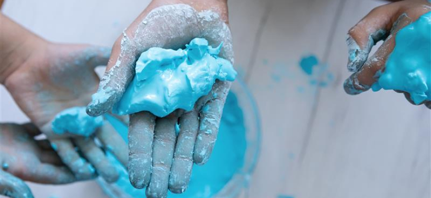 childs hand with blue goo