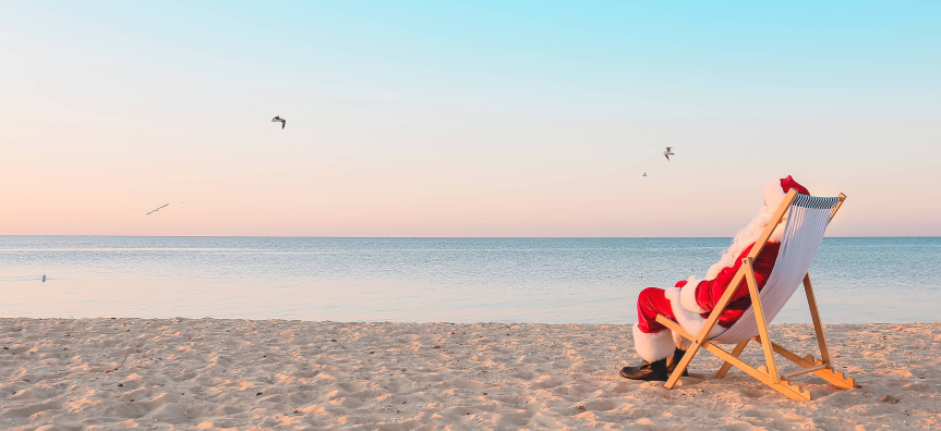 Santa sitting by the beach 