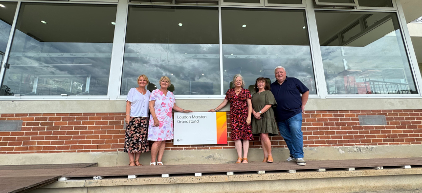 Mayor Sue Heins and members of the Laudon & Marston family unveil sign