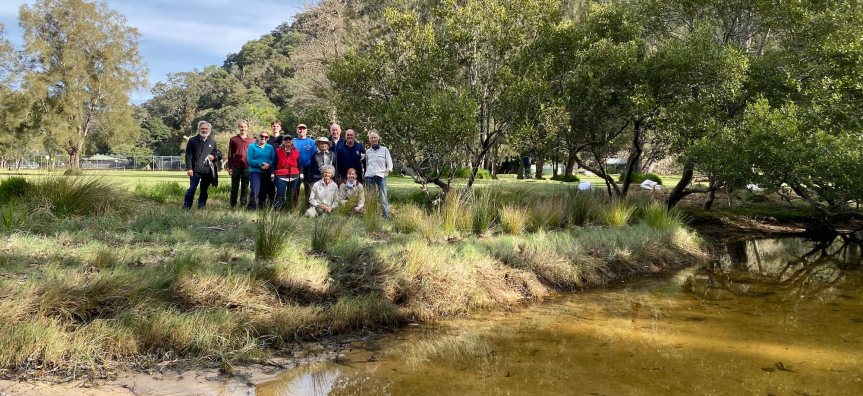 group photo of volunteers across the river