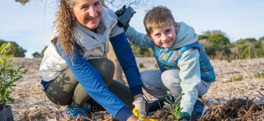 Mother and son planting a tree