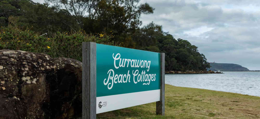 Currawong Beach Cottages sign