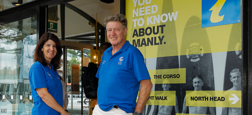 2 volunteers stand in front of the Manly Visitor Information Centre