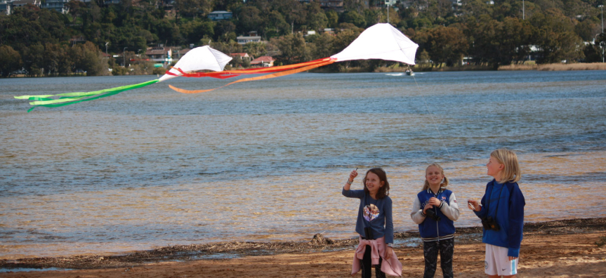 Children playing with a kite on the beach