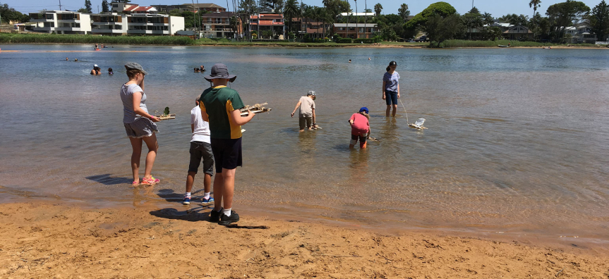 Children and educators playing in the lagoon