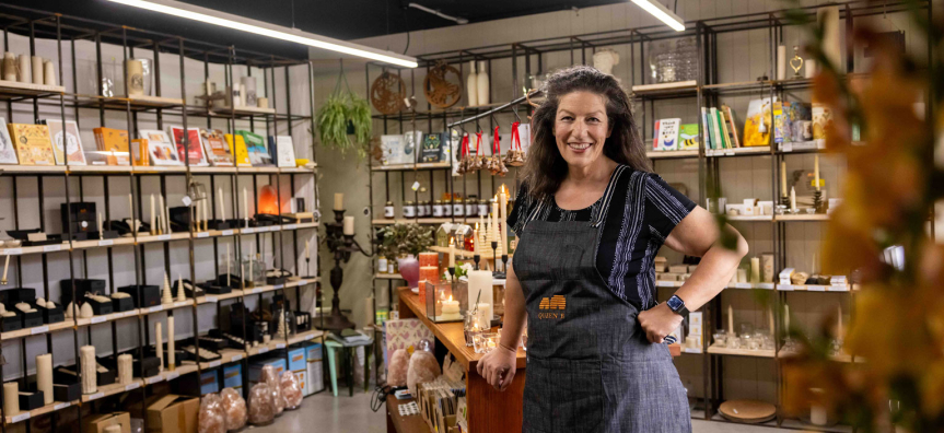 Queen B shopkeeper standing in their store