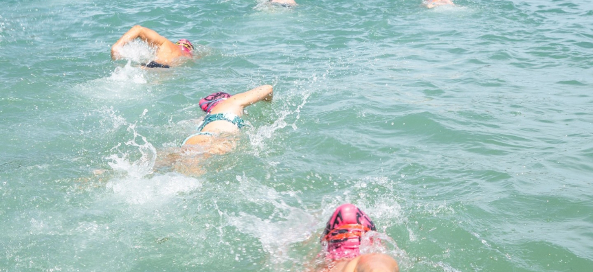 Crowd of people swimming in an ocean event