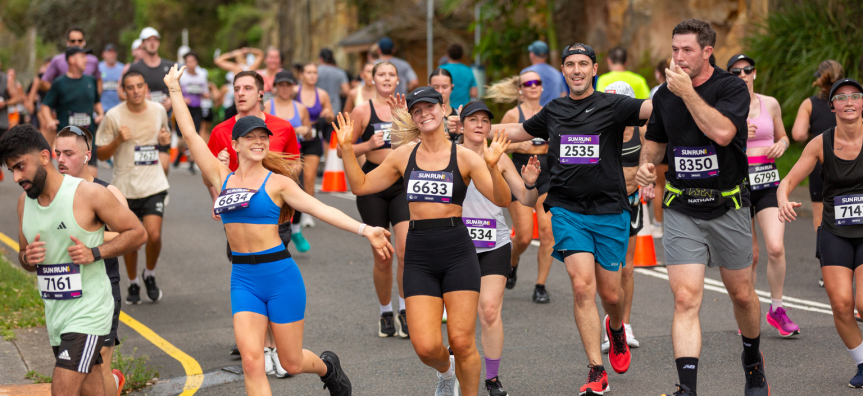 Runners at Sun Run going down a hill