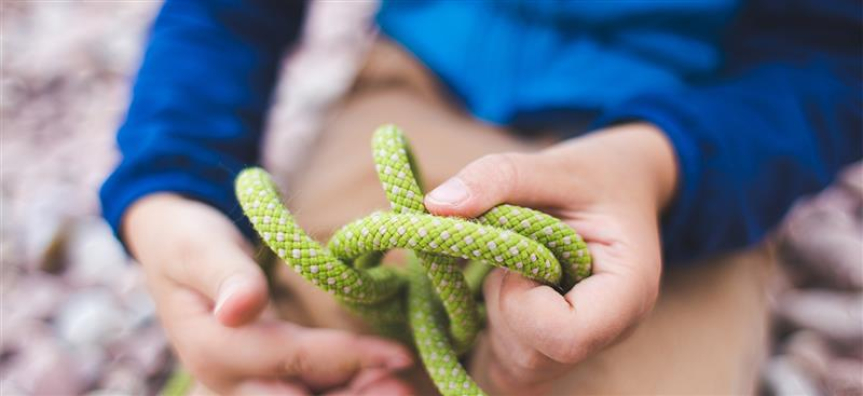 Kids hands tying knots