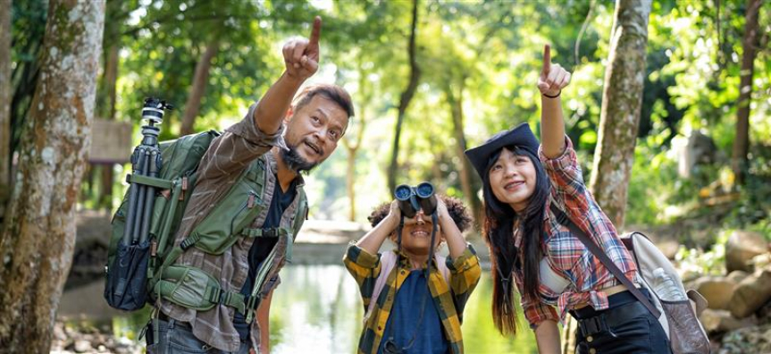 Family with binoculars in nature