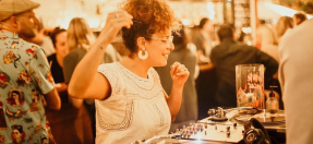 Photo of a DJ having a great time, spinning a record and dancing
