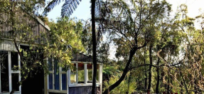 Light grey building set amongst the verdant national park.