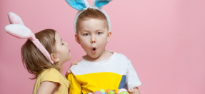 Kids holding basket full of eggs