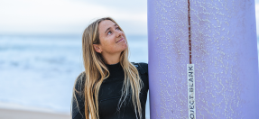 Surfer Tully White looks up at her surfboard
