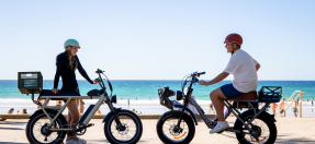 boy a girl on ebikes at manly beach