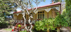 The front of the property at 34 Stuart Street, Manly, showing the front façade and yard of the house. 