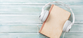 White headphones around a book