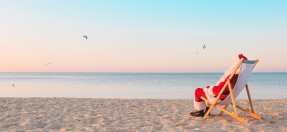 Santa sitting by the beach 