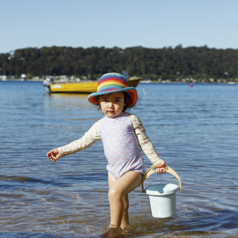 Girl on beach with bucket