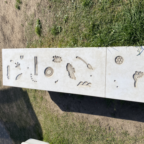 Artwork embedded into concrete slabs in garden